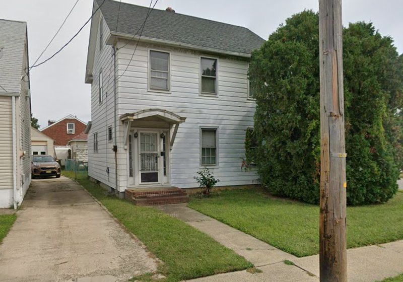 Two-story home with a white front porch in South River, NJ