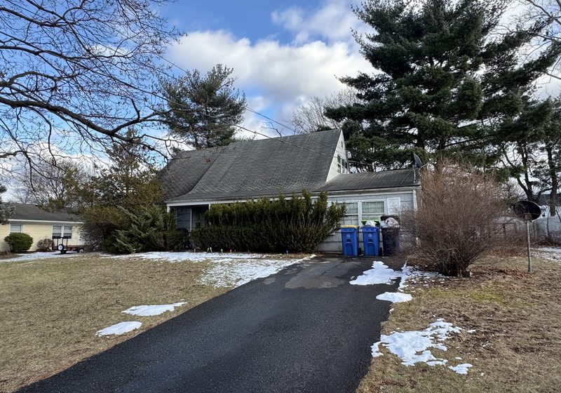 Ranch home with a long driveway in winter in Somerset, NJ